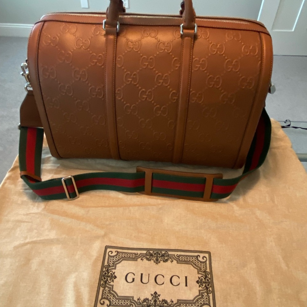 Gucci Duffel Bag with Signature Web Strap
Travel Bag